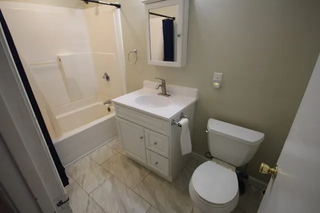 a white toilet sitting next to a bathroom sink