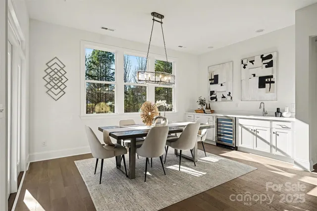 a large kitchen with a table and chairs