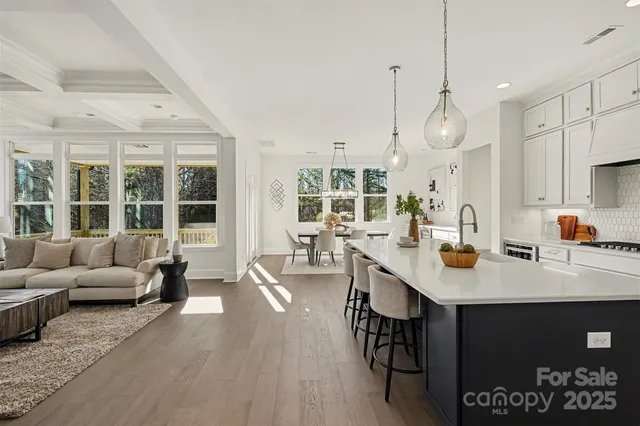a spacious bathroom with double vanity a window and a mirror