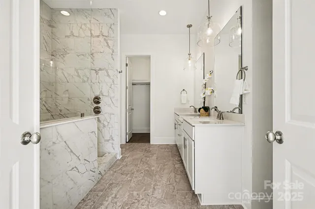 a bedroom with a bed mirror and window