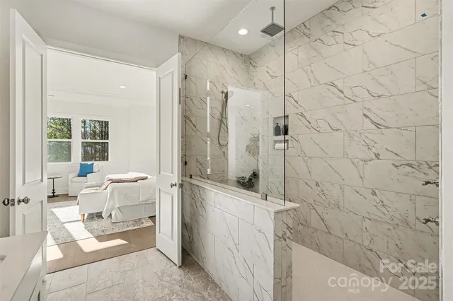 a view of a dining room and livingroom with furniture wooden floor a chandelier