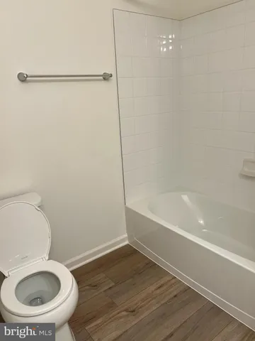 a bathroom with a toilet and a bathtub