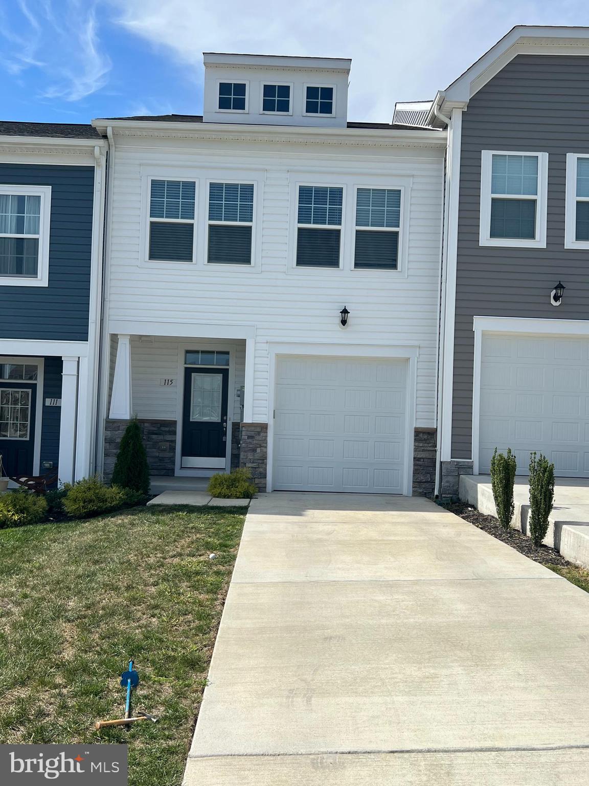 115 Clifton Manor Falling Waters, WV 25419 - Photo 2 of 29 a front view of a house with garden