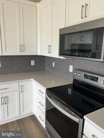 a kitchen with a stove and a microwave