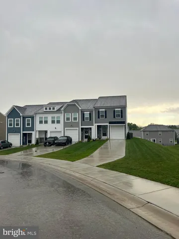 a view of house with outdoor space and parking