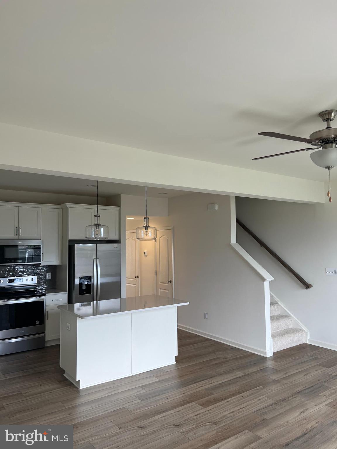 115 Clifton Manor Falling Waters, WV 25419 - Photo 3 of 29 a large kitchen with cabinets wooden floor and stainless steel appliances