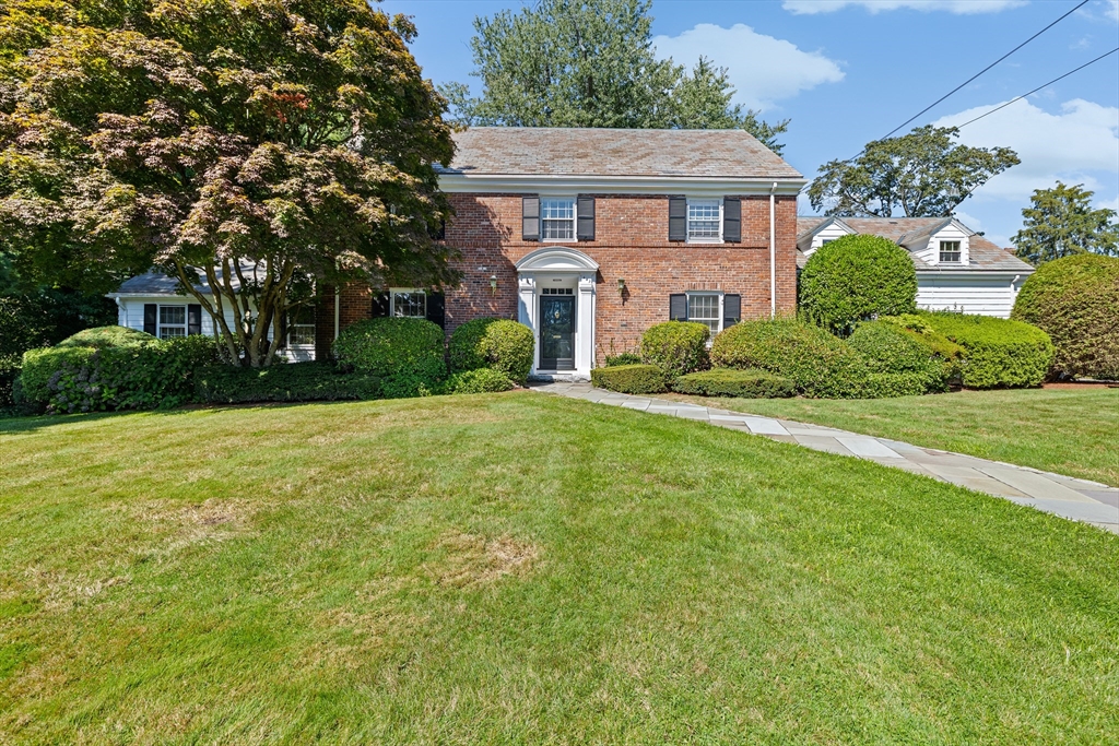443 Chestnut Street Newton, MA 02468 - Photo 1 of 28 a brick house with a big yard plants and big trees