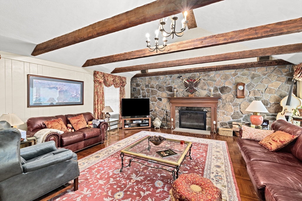 443 Chestnut Street Newton, MA 02468 - Photo 16 of 28 a living room with furniture a flat screen tv and a fireplace