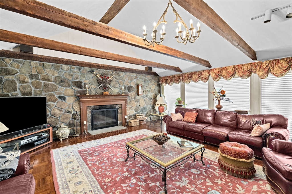 443 Chestnut Street Newton, MA 02468 - Photo 17 of 28 a living room with furniture a flat screen tv and a fireplace