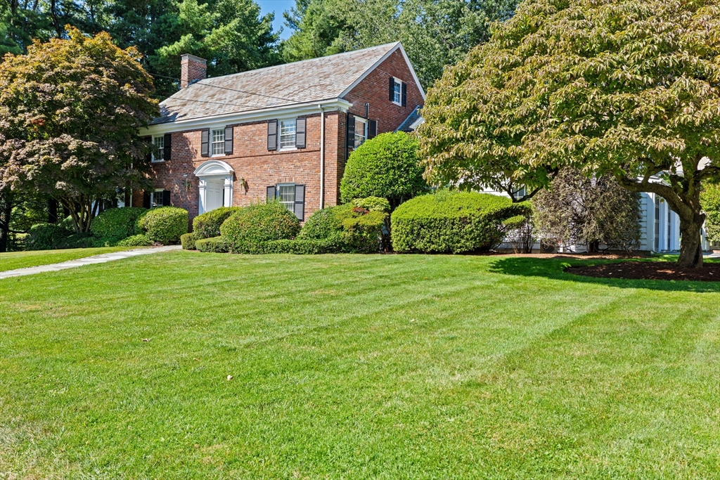 443 Chestnut Street Newton, MA 02468 - Photo 2 of 28 a view of a brick house with a big yard and large trees