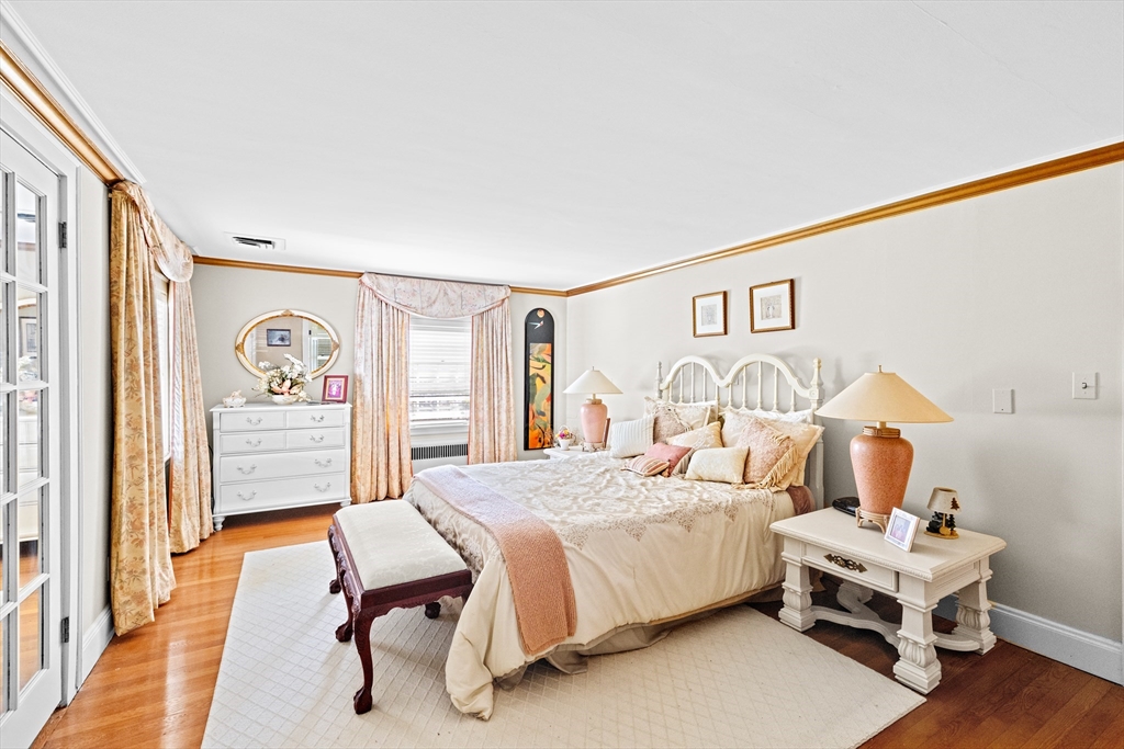 443 Chestnut Street Newton, MA 02468 - Photo 21 of 28 a bedroom with a bed and wooden floor
