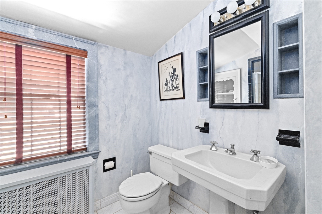 443 Chestnut Street Newton, MA 02468 - Photo 26 of 28 a bathroom with a toilet a sink and a large mirror