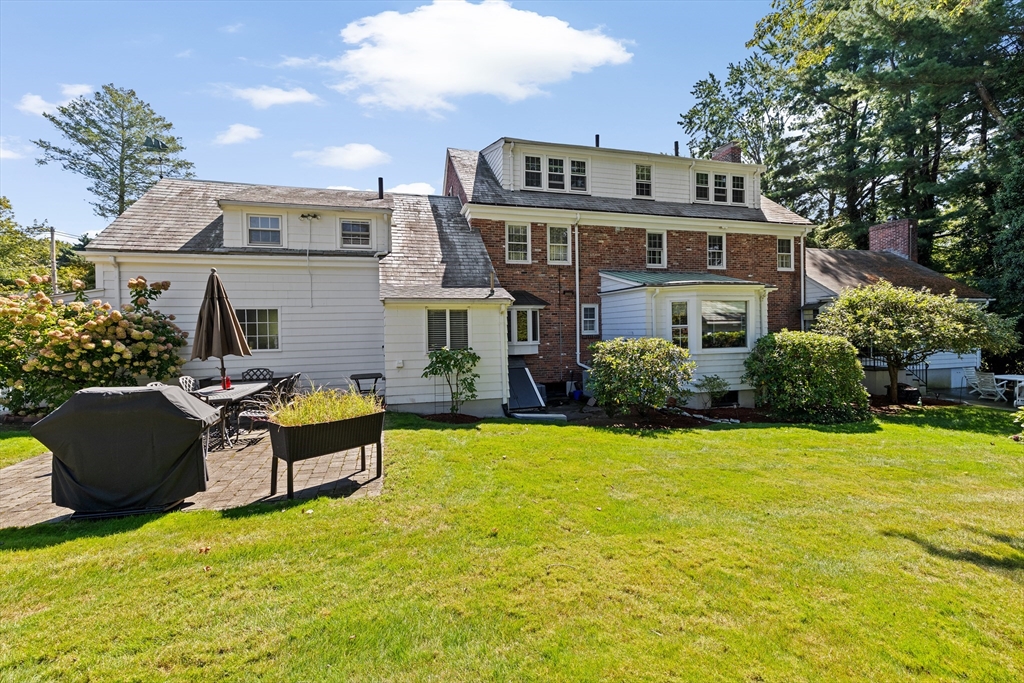 443 Chestnut Street Newton, MA 02468 - Photo 3 of 28 a front view of house with yard and trees in the background