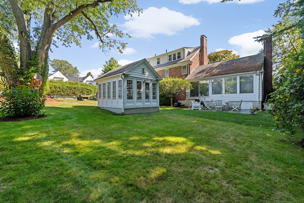 443 Chestnut Street Newton, MA 02468 - Photo 5 of 28 a view of a house next to a big yard and large trees