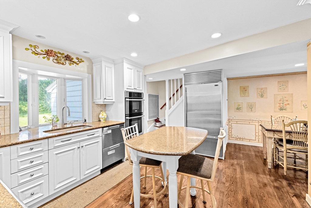 443 Chestnut Street Newton, MA 02468 - Photo 9 of 28 a kitchen with stainless steel appliances a dining table chairs and granite counter tops
