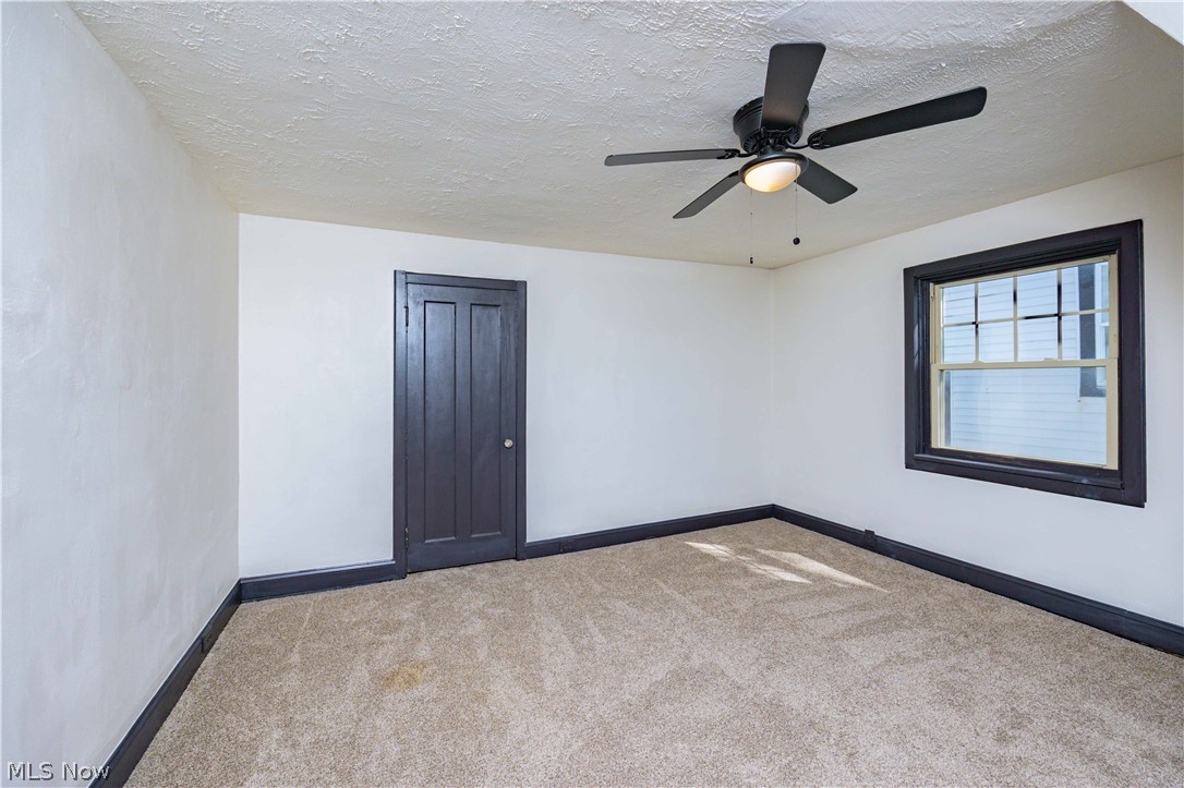3254 Redwood Road Cleveland Heights, OH 44118 - Photo 22 of 49 Spare room with ceiling fan, carpet floors, and a textured ceiling