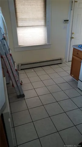 a bathroom with a granite countertop bathtub shower and toilet