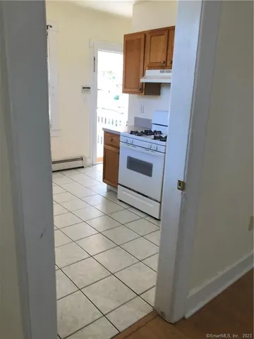 a kitchen with a stove and a refrigerator