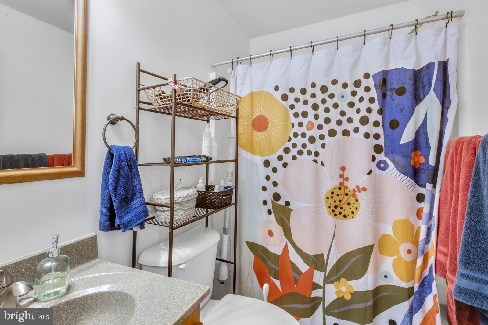 134 South 46th Street, Unit C Philadelphia, PA 19139 - Photo 11 of 17 a bathroom with a sink toilet and shower curtain
