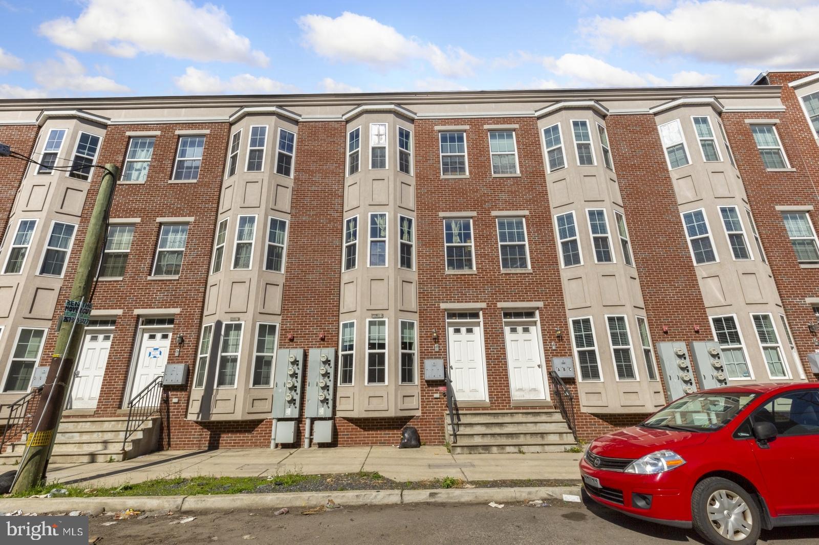134 South 46th Street, Unit C Philadelphia, PA 19139 - Photo 17 of 17 a front view of a residential apartment building with a yard