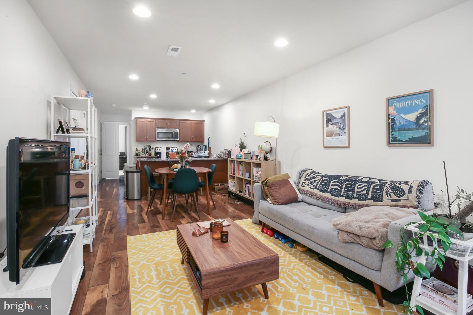 134 South 46th Street, Unit C Philadelphia, PA 19139 - Photo 2 of 17 a living room with furniture and a flat screen tv