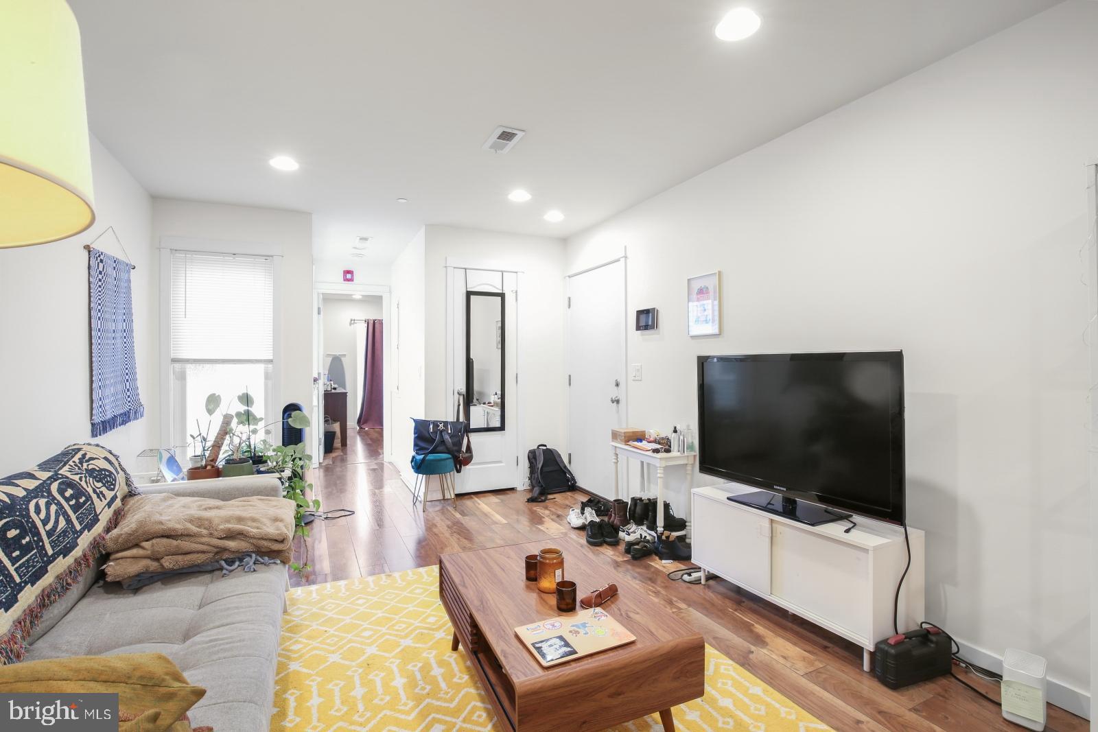 134 South 46th Street, Unit C Philadelphia, PA 19139 - Photo 3 of 17 a living room with furniture and a flat screen tv
