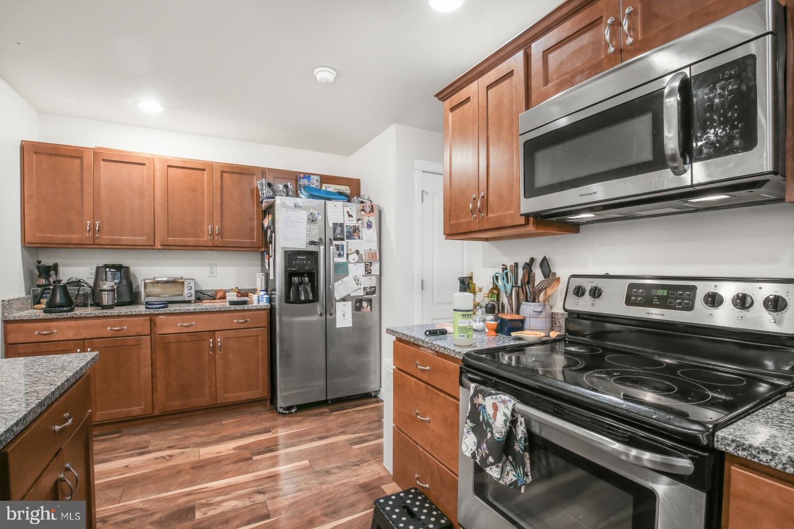 134 South 46th Street, Unit C Philadelphia, PA 19139 - Photo 7 of 17 a kitchen with a stove and a microwave