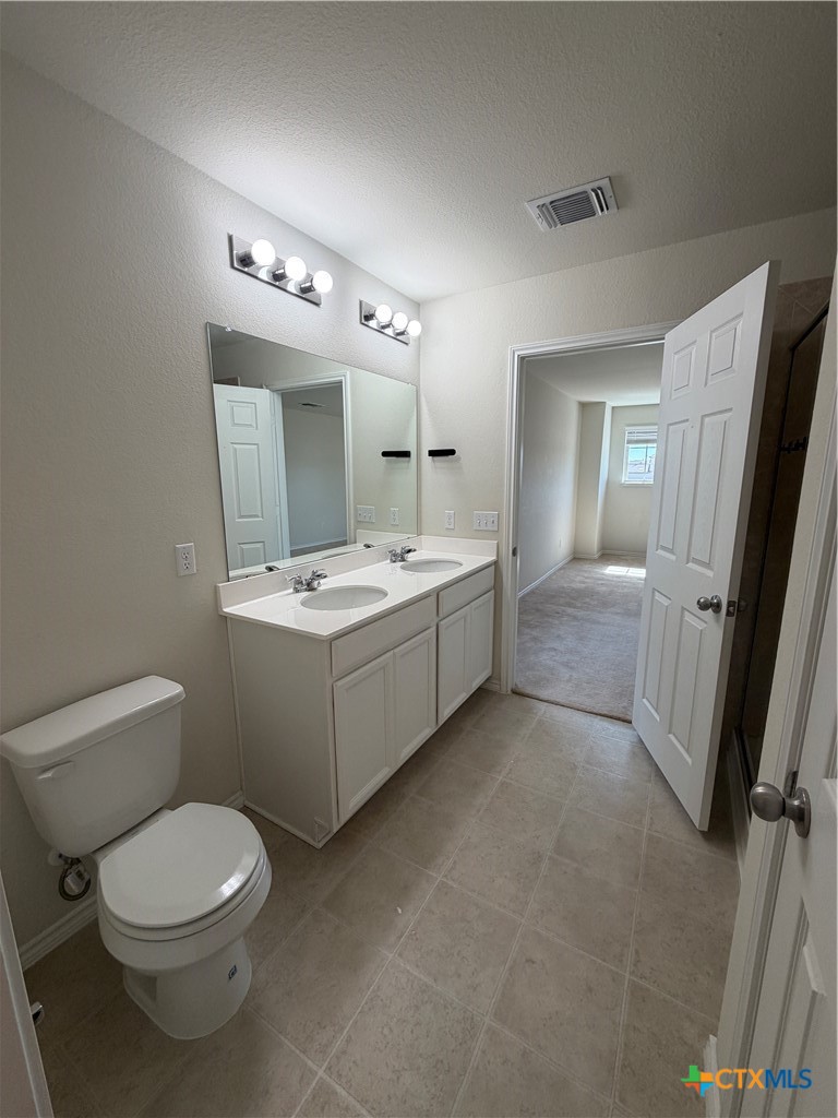 620 English Oak Street Georgetown, TX 78626 - Photo 17 of 29 a bathroom with a toilet sink and mirror