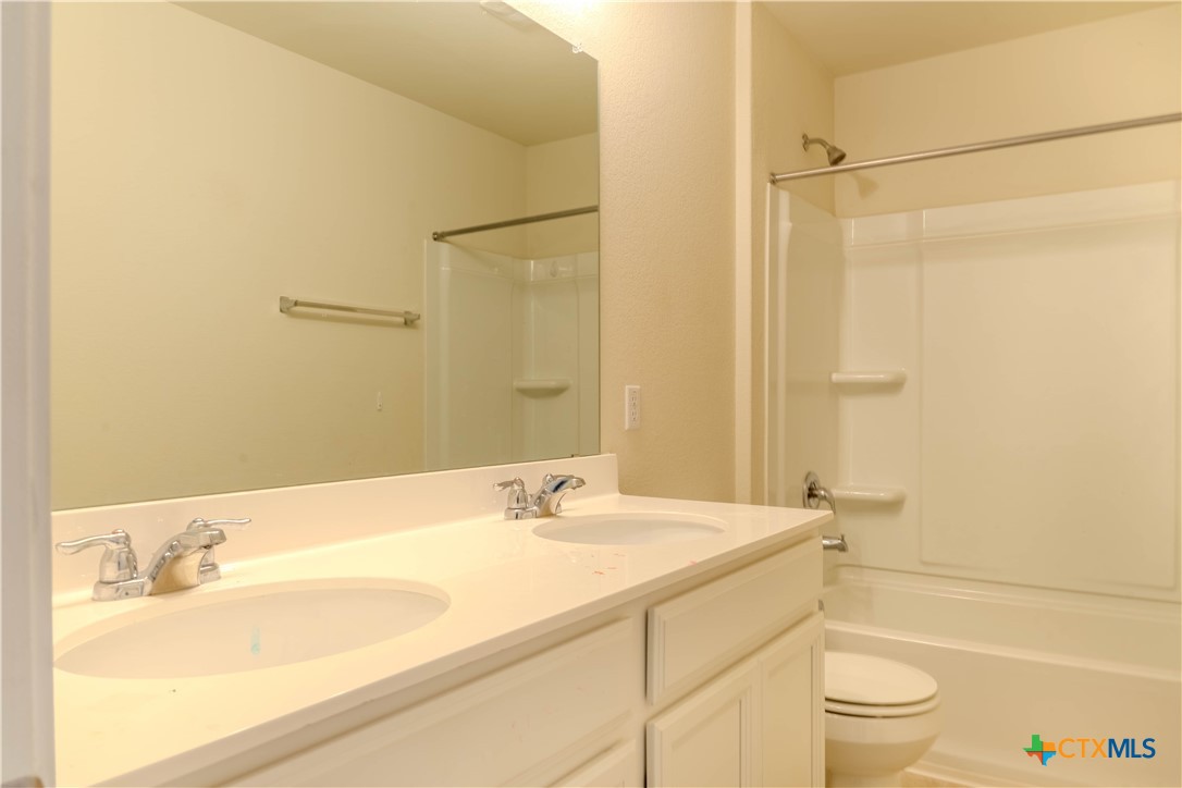 620 English Oak Street Georgetown, TX 78626 - Photo 24 of 29 a bathroom with a granite countertop sink toilet and shower