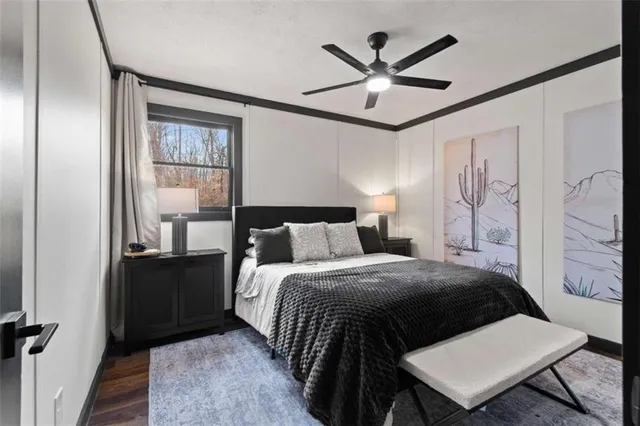 a bed room with a bed and a painting on the wall