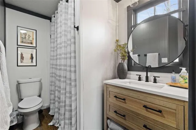 a bathroom with a toilet sink and mirror