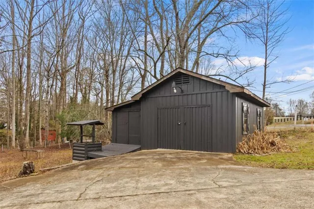 a backyard of a house with table and chairs