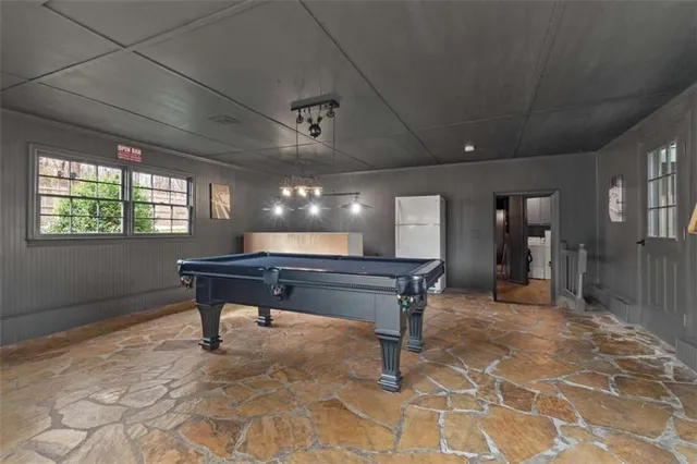 a room with pool tables and windows