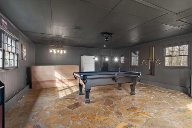 a view of a room with a large window and chandelier