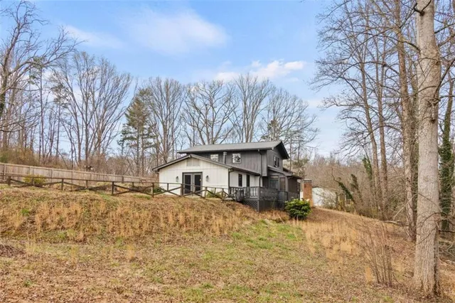 a front view of a house with a yard covered in snow