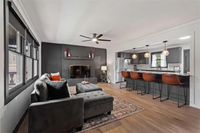 a living room with furniture a fireplace and a flat screen tv