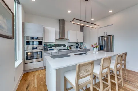 a kitchen with kitchen island a counter space a sink and appliances