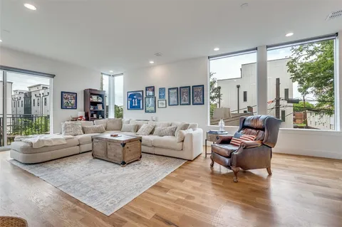 a living room with fireplace furniture and a large window