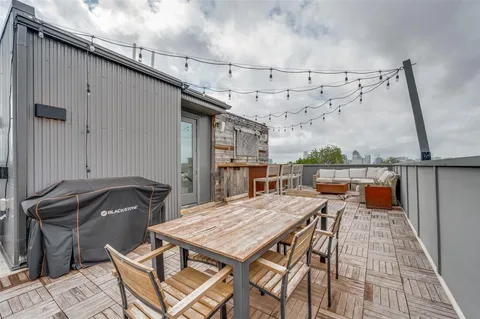 a terrace of a house with outdoor seating