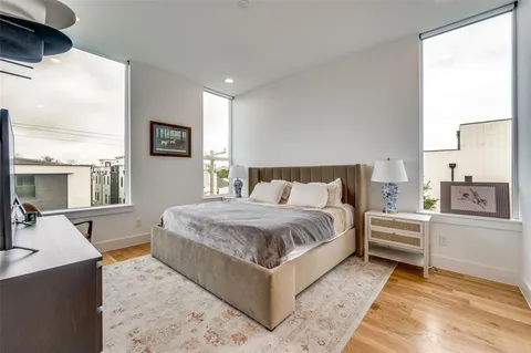 a bedroom with a large bed and a large window