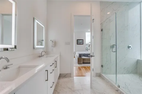 a spacious bathroom with a shower sink and mirror