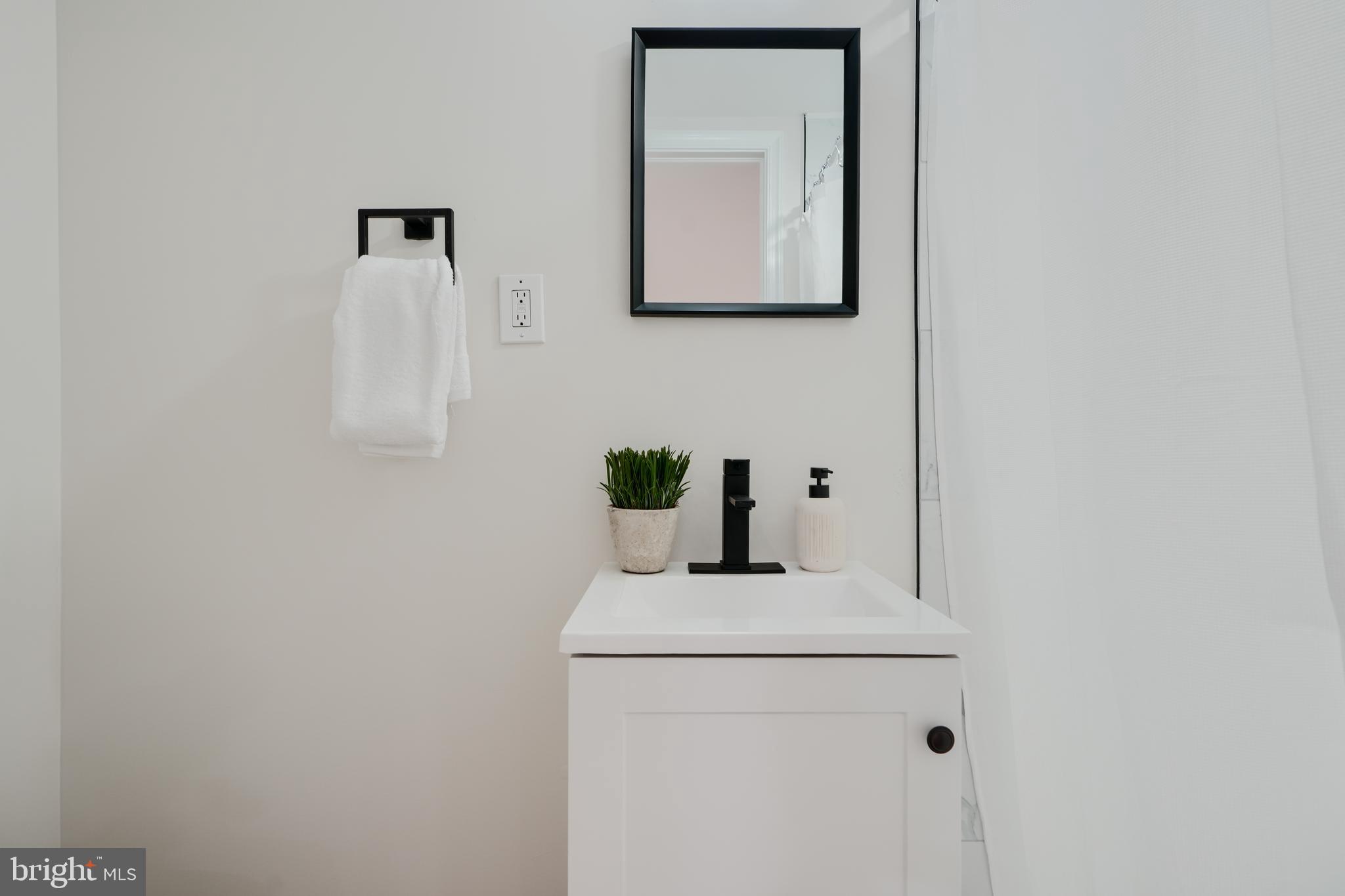 1836 Colmar Road Baltimore, MD 21207 - Photo 36 of 47 a bathroom with a sink and a mirror