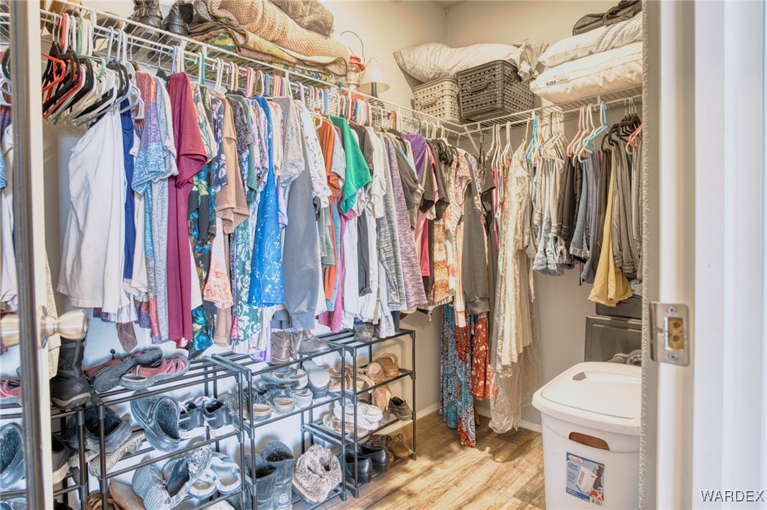 4496 Cove Road Golden Valley, AZ 86413 - Photo 15 of 27 a view of walk in closet with clothes