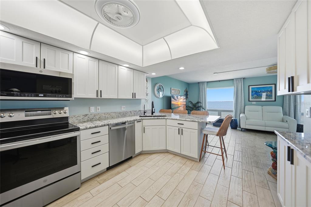 1 Colony Point Drive, Unit A10 Punta Gorda, FL 33950 - Photo 9 of 31 a kitchen with stainless steel appliances granite countertop a stove and a sink