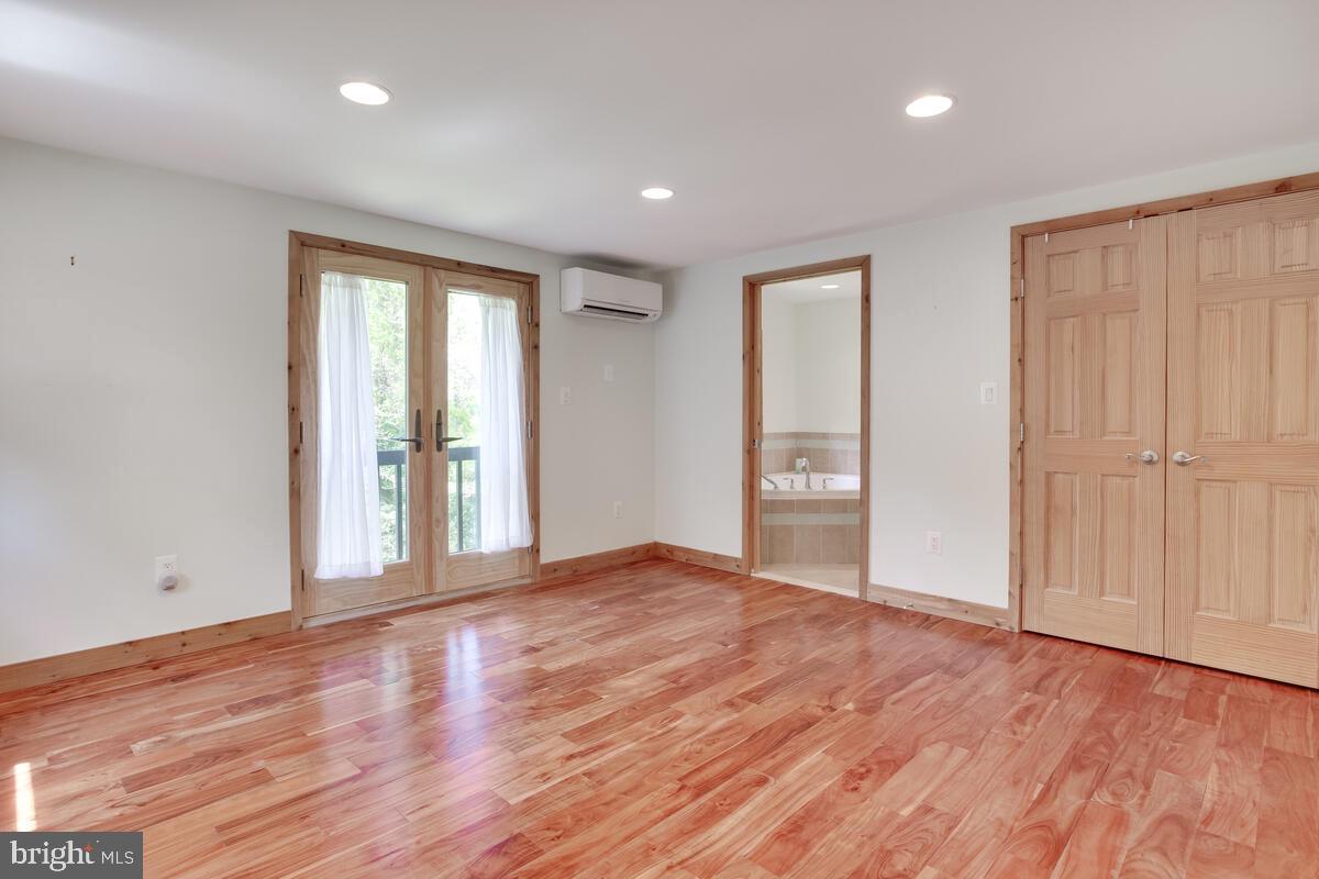 2359 Acacia Road Port Republic, MD 20676 - Photo 22 of 69 a view of an empty room with wooden floor and a window