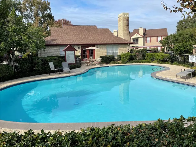 a view of a swimming pool with a patio