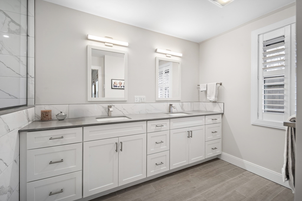 186 Mason Terrace, Unit 186 Brookline, MA 02446 - Photo 12 of 27 a bathroom with double sink and a mirror