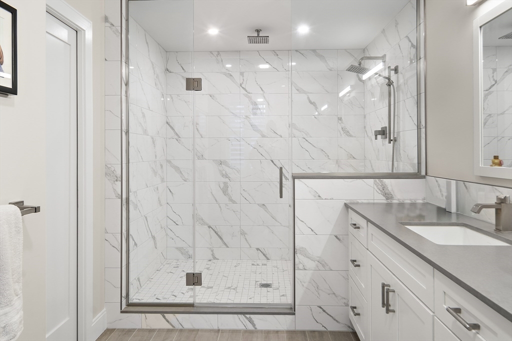 186 Mason Terrace, Unit 186 Brookline, MA 02446 - Photo 13 of 27 a bathroom with a shower and a sink
