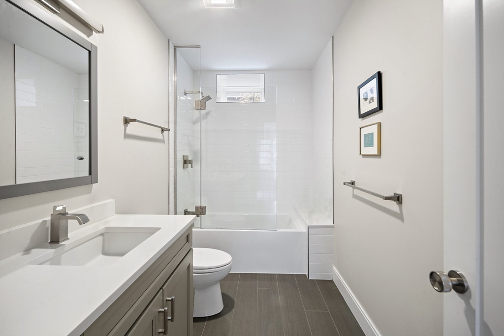 186 Mason Terrace, Unit 186 Brookline, MA 02446 - Photo 16 of 27 a bathroom with a sink toilet and shower