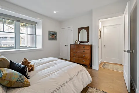 a bedroom with a bed and wooden floor